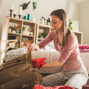 A daypack and travel gear organized on a lodge floor